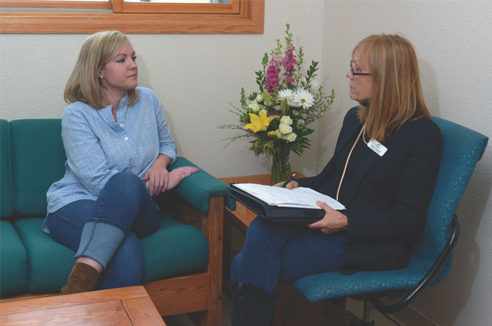 Two women sitting inside of Harmony Recovery, our medically monitored detox near Denver, having a therapy session