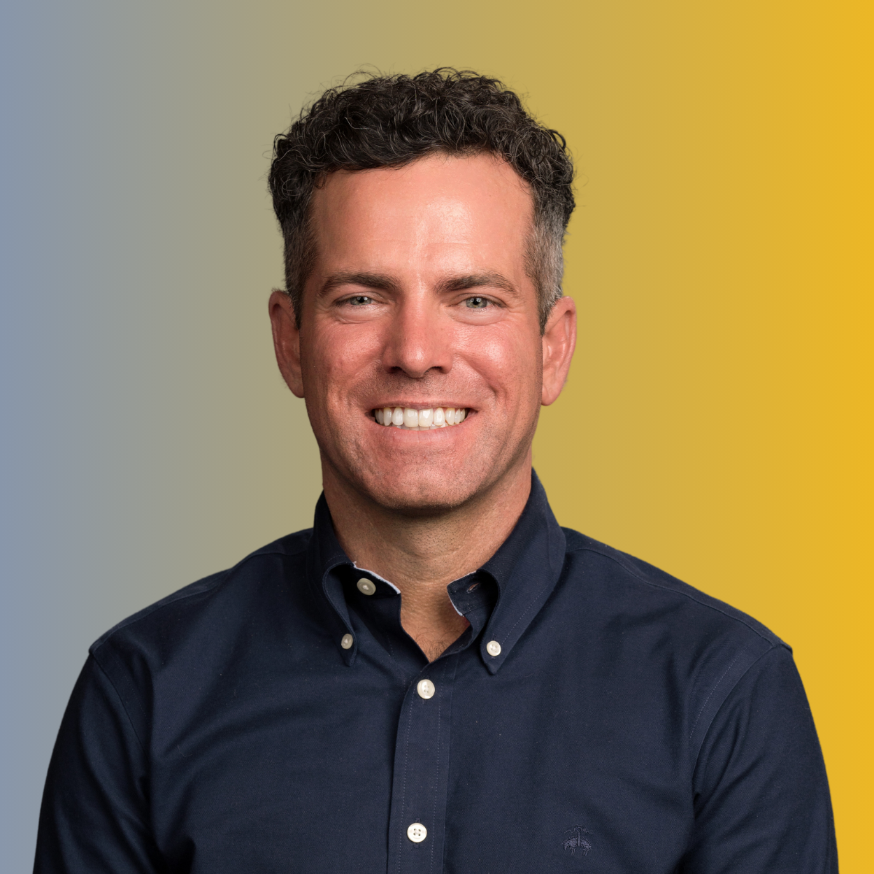 Man sitting inside and smiling at Harmony Recovery, our Colorado rehab centers in Estes Park